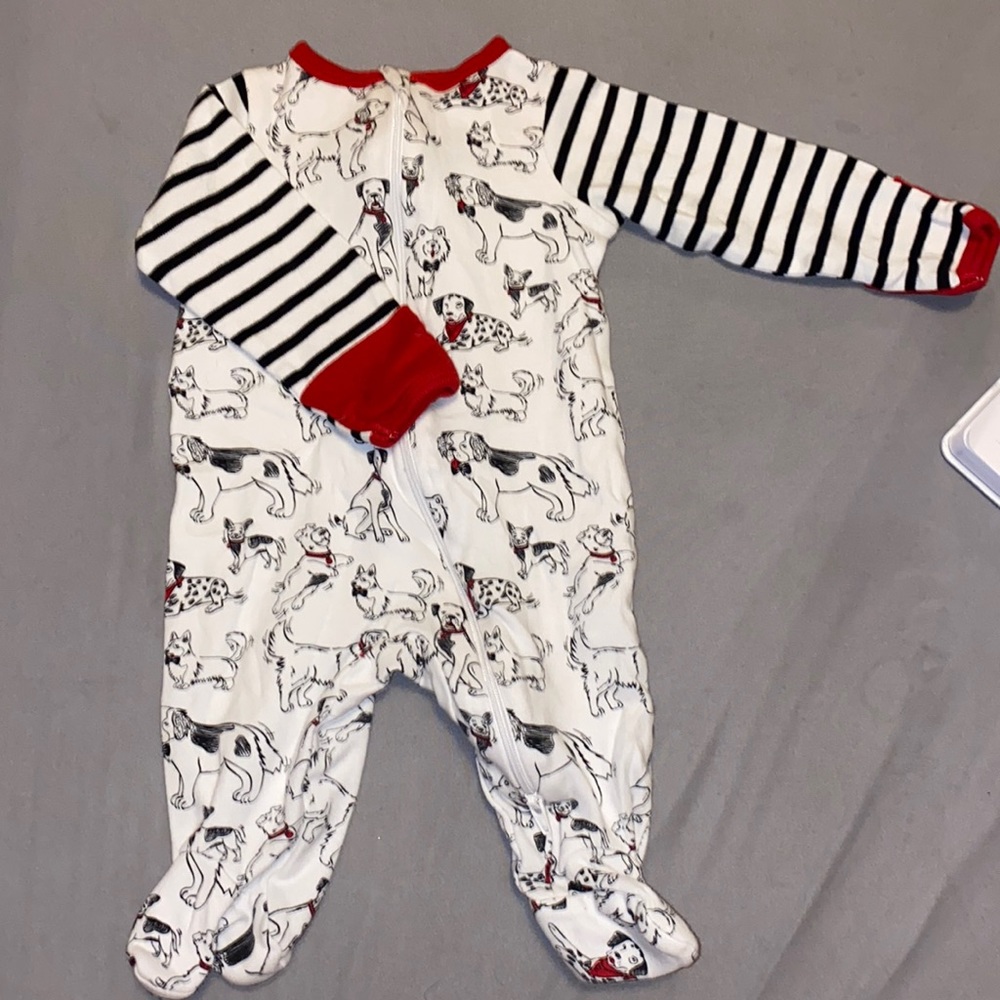 White, red, and black zip up footie pajamas